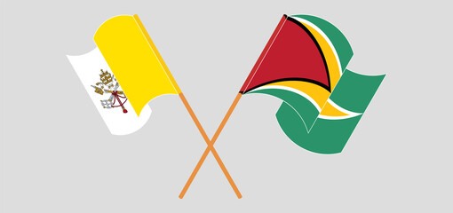 Crossed and waving flags of Vatican and Guyana