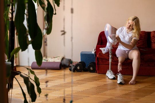 Removing Leg Prosthesis At Living Room