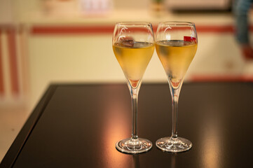Tasting of cold brut Champagne sparkling wine  in underground cellars of wine house in Reims, Champagne, France