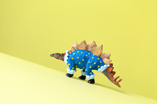 Toy dinosaur walking uphill