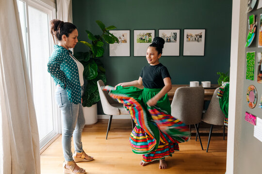 Mother checking on daughter her new traditional Mexican skirt