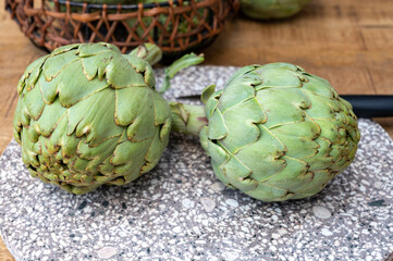 Fototapeta premium Fresh ripe green artichokes heads ready to cook