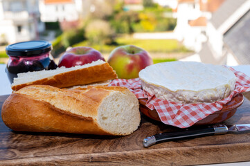 French breakfast with fresh baked baguette bread and camembert chees from Normandy, served outdoor with nice city view