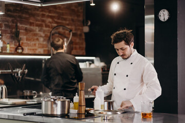 Male chef preparing food on stove