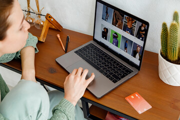 Woman choosing outfit in internet shop