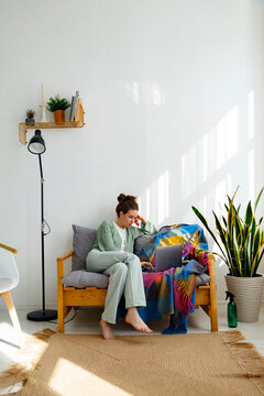 Woman ordering goods via laptop at home