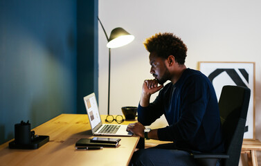 Black freelancer thinking over project in workplace