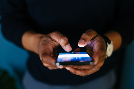 Anonymous black man using smartphone