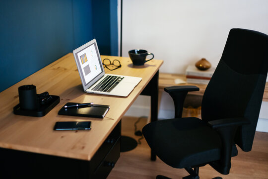 Desk with laptop and stationery in workplace