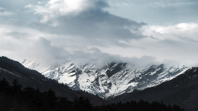4K Timelapse stock video of clouds over snow mountains during monsoon near Kasol, Manali, Kullu, Himachal Pradesh Tourism, India