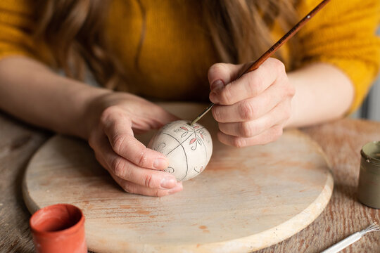 Woman's hands making decoration easter egg
