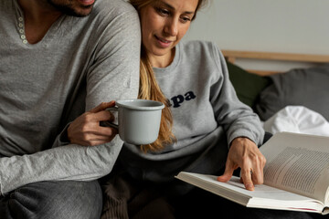 couple in bed reading book together