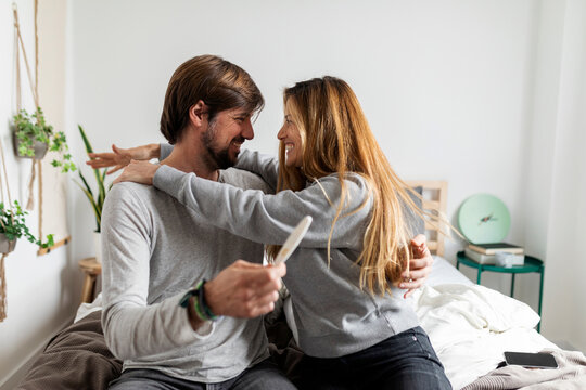 couple holding positive pregnancy test