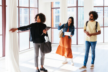 Diverse couple asking questions to black realtor