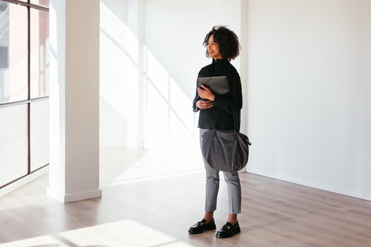 Black real estate agent in spacious apartment