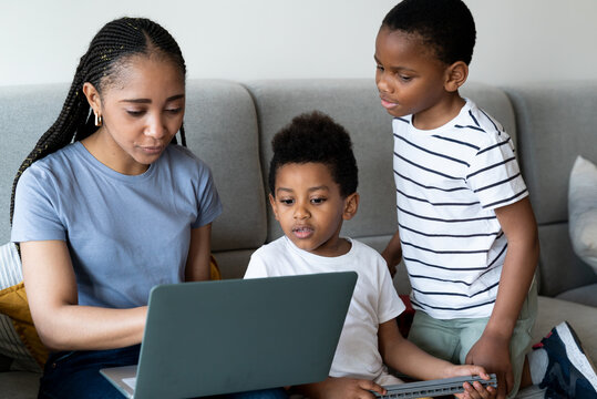 Mother working from home with her children.