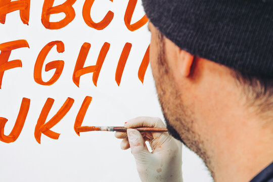 Street Artist Working In Studio On Typography