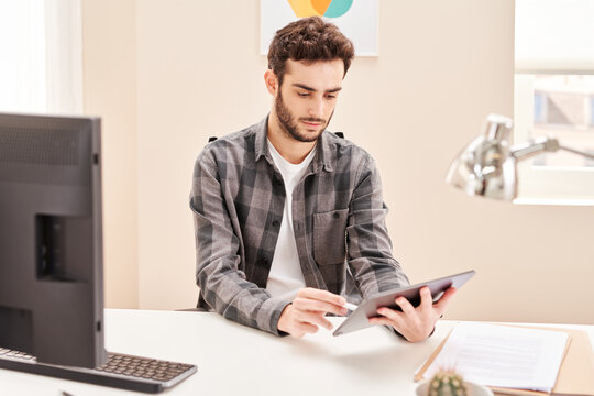 Male designer drawing on tablet in workplace