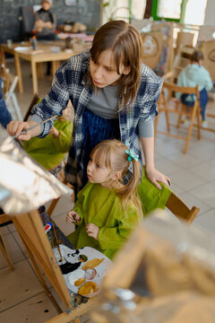 teacher and her young pupils during the art class