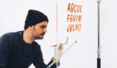 Street Artist Working In Studio On Typography