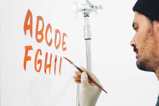 Street Artist Working In Studio On Typography