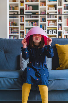 Pretty Child Peeking from a Pink Easter Egg at Home