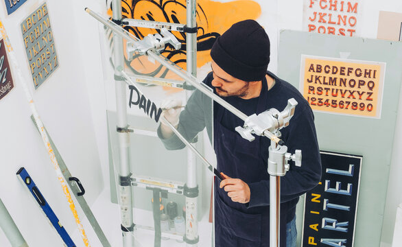 Street Artist Working In Studio On Typography