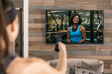 Home: Woman Uses Remote To Set Up Livestream Workout Class