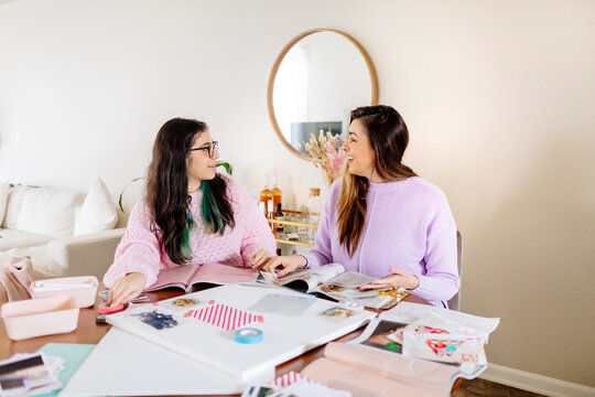 Teen girl and mother making a visual board