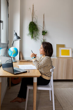 kid sitting on desk looking away