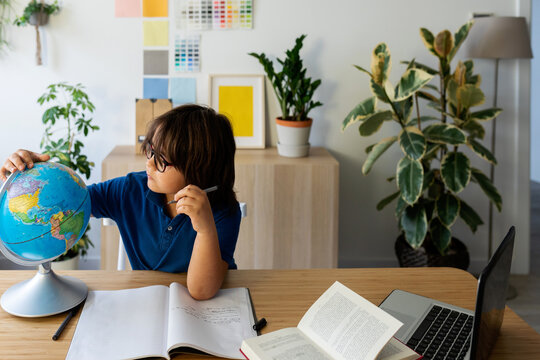 kid sitting on desk studying 