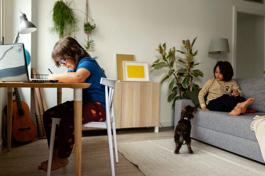 kid sitting on desk studying 