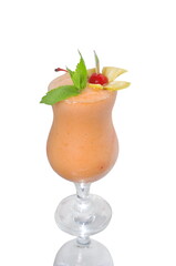 yellow smoothie in glass decorated with mint and cherry isolated on white