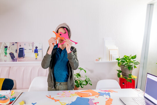 Boy showing paper figures 