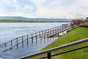 A ramp to descend to the lower embankment partially flooded with water