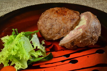 Fried cutlet with salad on red plate with sauce for restaurant menu