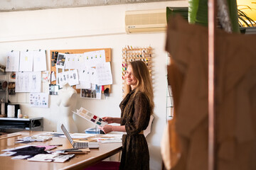 Woman fashion designer working in her sewing atelier