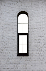 window in a white brick wall