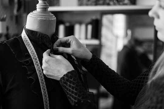 Woman fashion designer working in her sewing atelier - Powered by Adobe