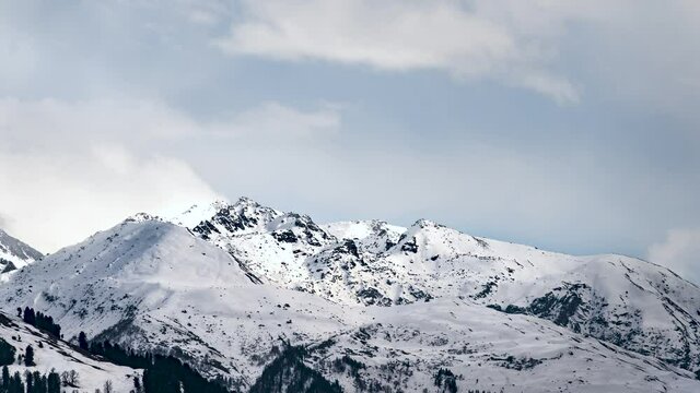 4K timelapse of clouds moving over snow mountains on a sunny day in Manali, Kullu, Himachal Pradesh Tourism, India