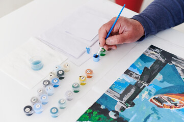 Man doing a paint by numbers picture