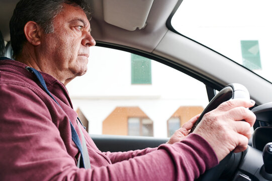 Mature man driving alone in a car