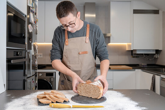Man inspecting baked bread on the kitchen