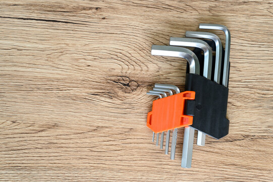 Set Of Hexagonal Keys And Screw On A Wooden Background. Knolling Style Shot..