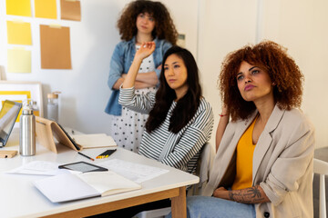 
Attentive Female Employees Listening To Presentation