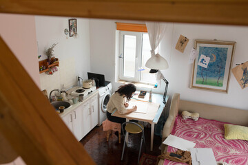 top view of a girl painting at the table
