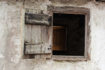 An open wooden window in a building.