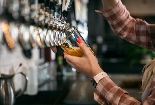 Brewery: Female Bartender Pouring a Beer
