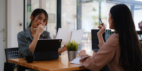 After leaving the meeting room, a businesswoman shows her plan from notes and discusses it with her team. financial and brainstorm concept.