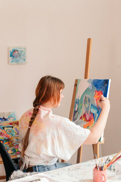 Artist painting in her studio